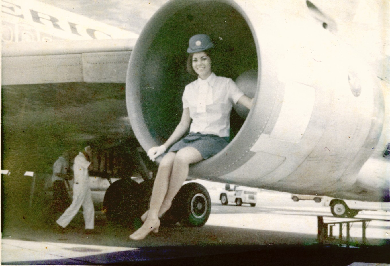 1970s Saigon, Venice poses in the engine of a Pan Am Boeing 707 during a Saigon transit.
